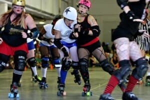 A Jacksonville RollerGirl blocks Gainesville Roller Rebels' Lil Mamma Jamma as she attempts to score a point at the Saints vs. Sinners roller derby game hosted by the Rebels.