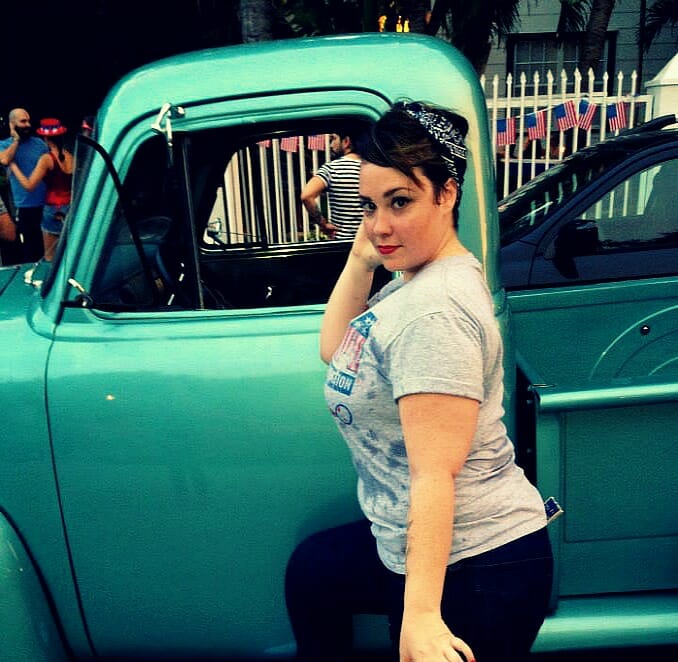 Woman posing near vintage car