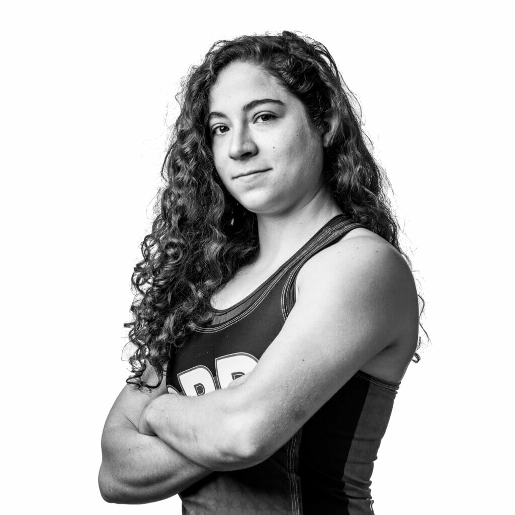 Black and white photo of Apex posing with her arms crossed