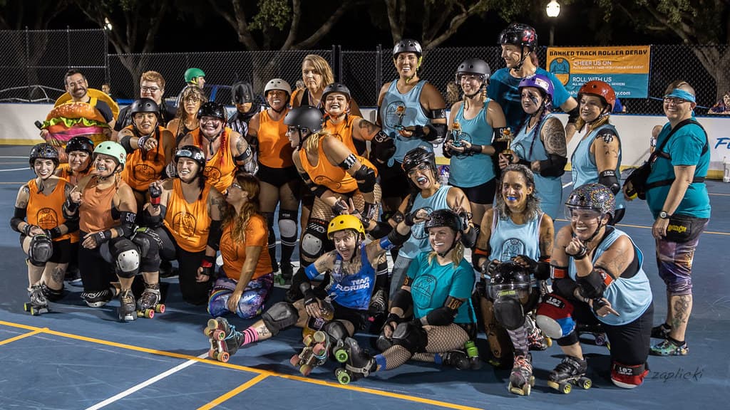 Sunshine Roller Derby poses with another team at a bout