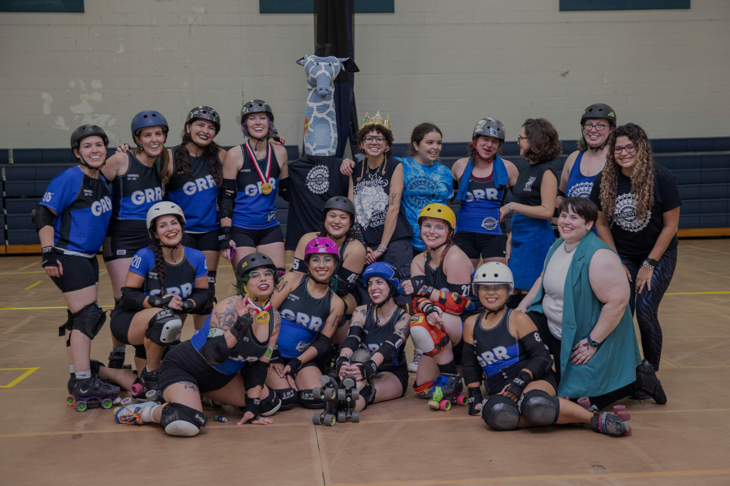 The entire GRR team, Riff Raff, and bench coaches pose together after a bout